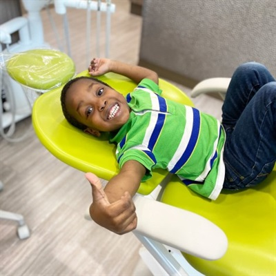 Patient in chair thumbs up